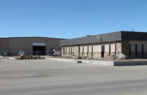 Two Buildings and a wood pile