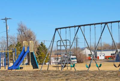 Playground with blue slide and swing set